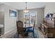 Inviting dining area featuring classic wood furniture, blue accents, and large windows for natural light at 4024 Town Center Rd, Harrisburg, NC 28075