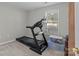 Bright workout area featuring a treadmill and natural light from the window at 4024 Town Center Rd, Harrisburg, NC 28075