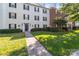 Stylish condo building with brick accents, black shutters, lush lawn, and well-maintained landscaping at 4024 Town Center Rd, Harrisburg, NC 28075