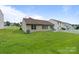 Well-maintained backyard with lush green grass, a patio area, and a privacy fence at 406 Courtland Ct, Kannapolis, NC 28081