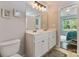 Bathroom with double sink vanity, white cabinets and a mirror with vanity lighting at 406 Courtland Ct, Kannapolis, NC 28081