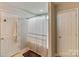 Bathroom featuring a shower with shower curtain, tiled floors and two storage closets at 406 Courtland Ct, Kannapolis, NC 28081