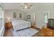 Bright bedroom featuring a ceiling fan, window, ensuite bathroom and dark hardwood floors at 406 Courtland Ct, Kannapolis, NC 28081