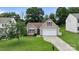 Charming one-story home featuring a well-manicured lawn and an attached two-car garage, enhancing curb appeal at 406 Courtland Ct, Kannapolis, NC 28081