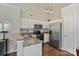 Modern kitchen featuring stainless steel appliances, stylish pendant lighting, and white cabinetry at 406 Courtland Ct, Kannapolis, NC 28081