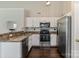 Well-appointed kitchen boasting stainless steel appliances, ample cabinet space, and modern finishes at 406 Courtland Ct, Kannapolis, NC 28081