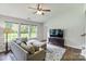 Cozy living room with a comfortable sofa, large windows, and a TV area for entertainment at 406 Courtland Ct, Kannapolis, NC 28081