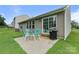 Back patio featuring outdoor seating and a grill, next to large windows on the house at 406 Courtland Ct, Kannapolis, NC 28081