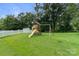 Outdoor backyard featuring a wooden playground set and a white fence in the background at 406 Courtland Ct, Kannapolis, NC 28081