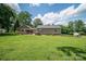 Beautiful backyard featuring a spacious lawn, covered patio, and additional shed for storage at 4441 Jim Wise Rd, Lincolnton, NC 28092