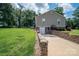 Exterior view of the basement entrance with a stone retaining wall, providing a functional and aesthetic appeal at 4441 Jim Wise Rd, Lincolnton, NC 28092