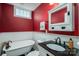 Elegant bathroom with a clawfoot tub, modern sink, and unique wall paneling at 4441 Jim Wise Rd, Lincolnton, NC 28092