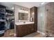 Well-lit bathroom featuring a large vanity, glass shower, and access to a walk-in closet at 4441 Jim Wise Rd, Lincolnton, NC 28092