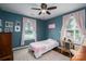 Bedroom with hardwood floors, large windows, pink curtains, and a ceiling fan at 4441 Jim Wise Rd, Lincolnton, NC 28092