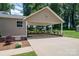 Spacious carport with stone base and red flowers for added curb appeal and shelter from the elements at 4441 Jim Wise Rd, Lincolnton, NC 28092