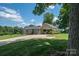 Attractive home featuring a convenient carport, beautiful landscaping, and a well-maintained lawn for outdoor enjoyment at 4441 Jim Wise Rd, Lincolnton, NC 28092