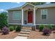 Inviting front entrance featuring a striking red door, stone steps, and tasteful landscaping, enhancing curb appeal at 4441 Jim Wise Rd, Lincolnton, NC 28092