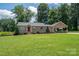 Charming home featuring a well-manicured lawn and a welcoming red front door, complemented by a convenient carport at 4441 Jim Wise Rd, Lincolnton, NC 28092