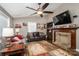 Cozy living room features a stone fireplace, plush seating, and a ceiling fan, perfect for relaxing and entertaining at 4441 Jim Wise Rd, Lincolnton, NC 28092