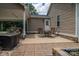 Back patio with dining area for entertaining guests, complemented by flower beds and exterior lighting at 4441 Jim Wise Rd, Lincolnton, NC 28092