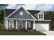 Charming single-Gathering home features stone accents, a covered porch, and a well-maintained lawn at 5119 Raging Creek Dr, Indian Trail, NC 28079
