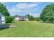 Expansive backyard with lush green lawn and charming home featuring a deck at 5211 Spring Gln, York, SC 29745