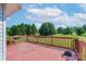 Lovely outdoor deck area with wood flooring and railings, overlooking lush greenery and a serene landscape at 5211 Spring Gln, York, SC 29745