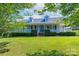 Charming home with a welcoming front porch and well-manicured lawn and blue door at 5211 Spring Gln, York, SC 29745