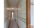 Long hallway with patterned wallpaper and carpeted floor leading to other rooms at 5211 Spring Gln, York, SC 29745