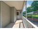 Covered porch with white railings and view of metal carport at 5211 Spring Gln, York, SC 29745