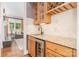 Stylish bar area featuring custom cabinetry, a sink, beverage cooler, and views into the living room at 5537 Challis View Ln, Charlotte, NC 28226