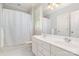 Well-maintained bathroom with a double sink vanity, a white shower curtain, and tile flooring at 5537 Challis View Ln, Charlotte, NC 28226