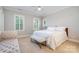 Serene bedroom with a plush bed, a decorative bench, and natural light from plantation-shuttered windows at 5537 Challis View Ln, Charlotte, NC 28226