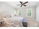Inviting bedroom with a ceiling fan, natural lighting, and a comfortable seating area at 5537 Challis View Ln, Charlotte, NC 28226