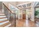 Elegant home foyer featuring hardwood floors, decorative lighting, and a staircase with ornate iron railing at 5537 Challis View Ln, Charlotte, NC 28226