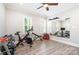 Bright home gym with wood floors, a mirrored wall, weights, and exercise machines at 5537 Challis View Ln, Charlotte, NC 28226
