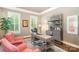 Comfortable office space with plenty of natural light, two pink chairs, and desk at 5537 Challis View Ln, Charlotte, NC 28226