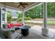 Covered patio offers comfortable seating, a ceiling fan, and a backyard view at 5537 Challis View Ln, Charlotte, NC 28226