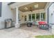 Covered patio with a ceiling fan, grill, and comfortable seating at 5537 Challis View Ln, Charlotte, NC 28226
