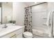 Bathroom with shower/tub combination, modern vanity, and stylish floral shower curtain at 5690 Granbury Dr, Kannapolis, NC 28081