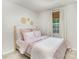 Charming bedroom with a floral comforter, light walls and a bright window view at 5690 Granbury Dr, Kannapolis, NC 28081