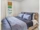 Comfortable bedroom featuring a textured comforter, light walls, and bright window view at 5690 Granbury Dr, Kannapolis, NC 28081