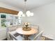 Breakfast nook featuring a cushioned bench seat and round table with four chairs at 5690 Granbury Dr, Kannapolis, NC 28081