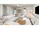 Bright living room featuring a large sectional sofa and an accent chair at 5690 Granbury Dr, Kannapolis, NC 28081