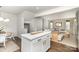 Bright living room featuring a modern white kitchen island and open floor plan layout at 5690 Granbury Dr, Kannapolis, NC 28081