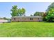 Expansive backyard with a well-maintained lawn and the home's brick exterior at 701 Mcswain Rd, Shelby, NC 28150