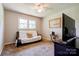 Cozy bedroom with futon, TV, ceiling fan, and natural light from a window at 701 Mcswain Rd, Shelby, NC 28150