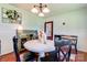 Dining room showcasing classic decor with white wainscoting, wood floors and chandelier lighting at 701 Mcswain Rd, Shelby, NC 28150