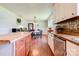Traditional kitchen with stainless steel appliances, countertops and wood floors flows into dining area at 701 Mcswain Rd, Shelby, NC 28150