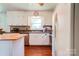 Bright kitchen featuring white cabinets, stainless steel appliances, and hardwood floors at 701 Mcswain Rd, Shelby, NC 28150